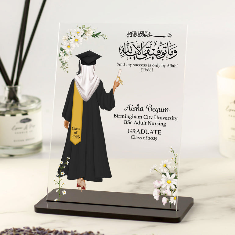 Personalised Islamic graduation plaque featuring a modest female graduate with hijab, floral design, and Arabic Quran verse, displayed on black acrylic stand.