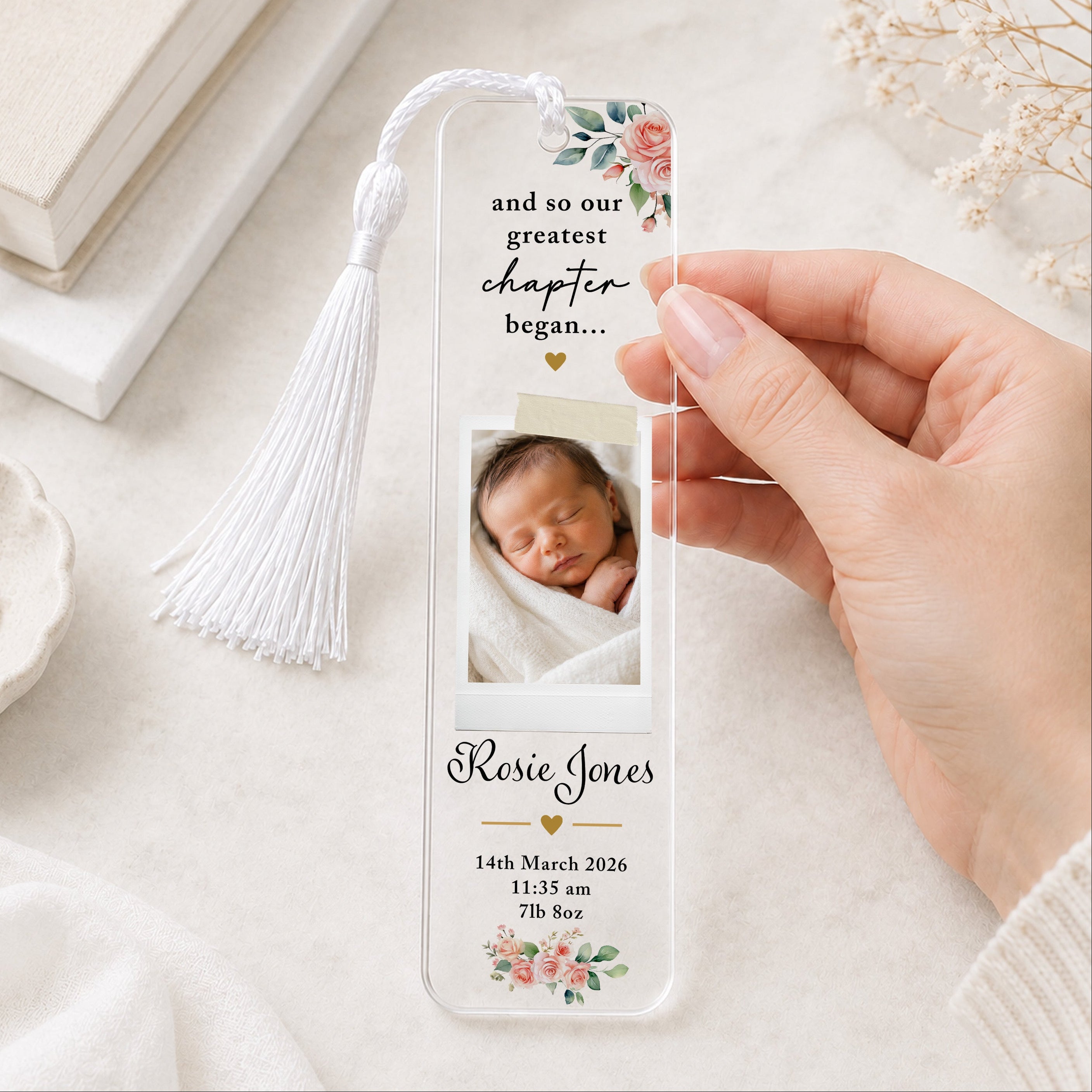 Personalised new baby photo bookmark with newborn picture, name, birth date, time and weight, pink floral design and white tassel.