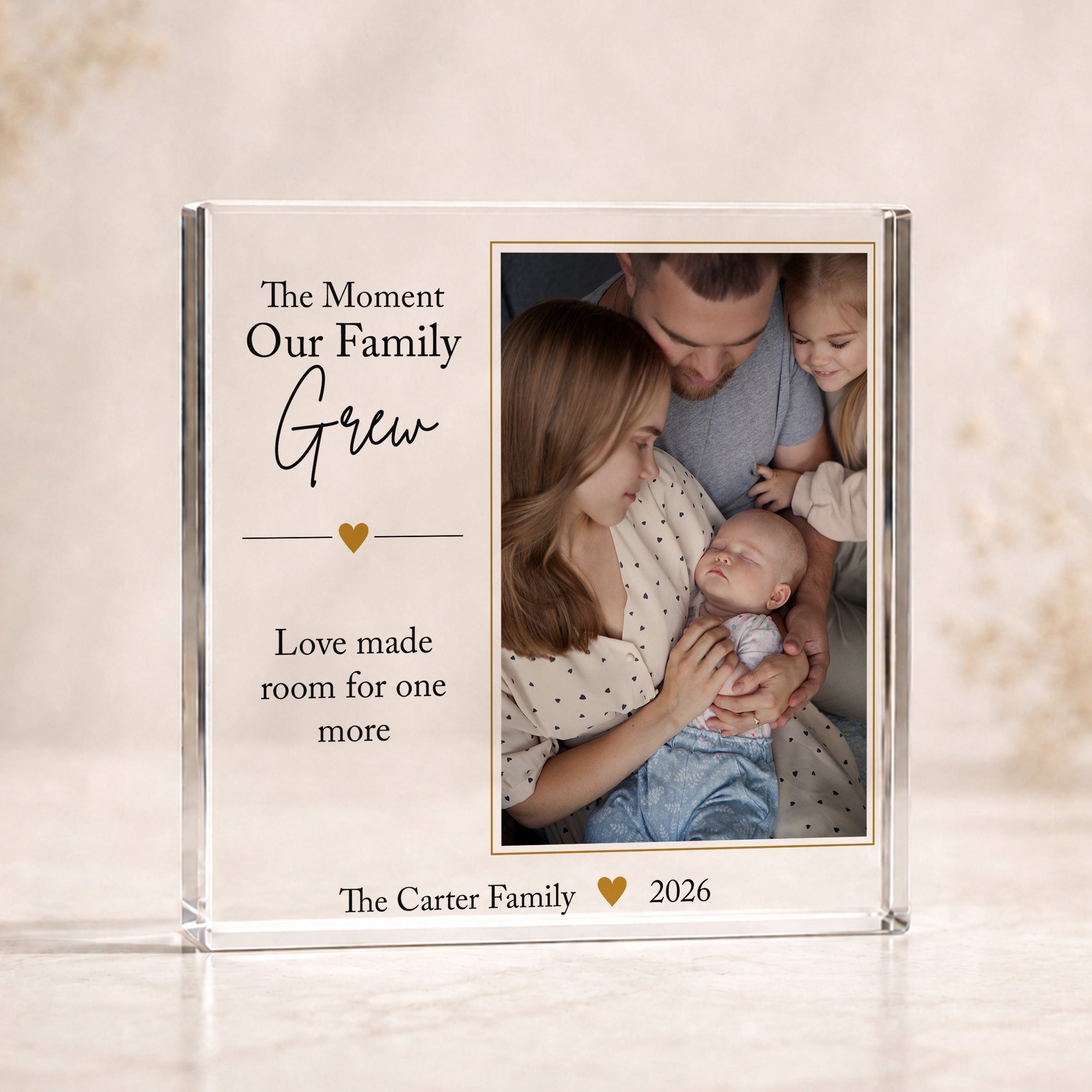 Personalised growing family acrylic photo block featuring parents, children and new baby with custom family name and year.