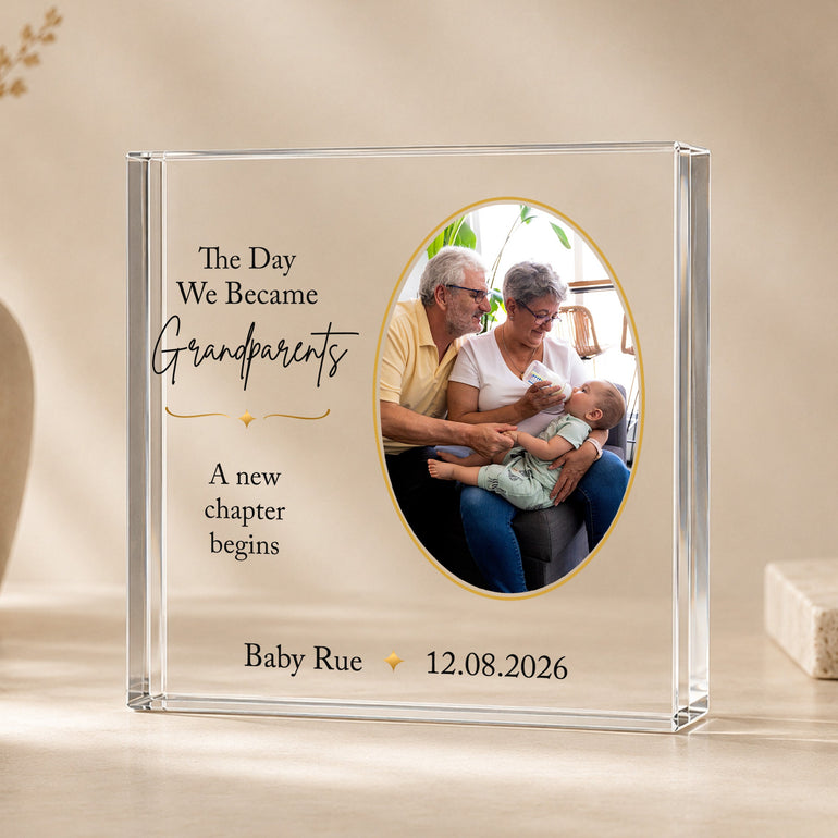 Personalised new grandparents acrylic photo block with Grandma and Grandad holding their new grandchild, personalised with baby's name and date.